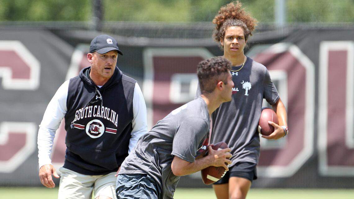 South Carolina offensive coordinator and QBs coach Marcus Satterfield works with Class of 2024 prospects Dante Reno and Jayden Bradford at the Shane Beamer Football Camp held Thursday, June 9, 2022.