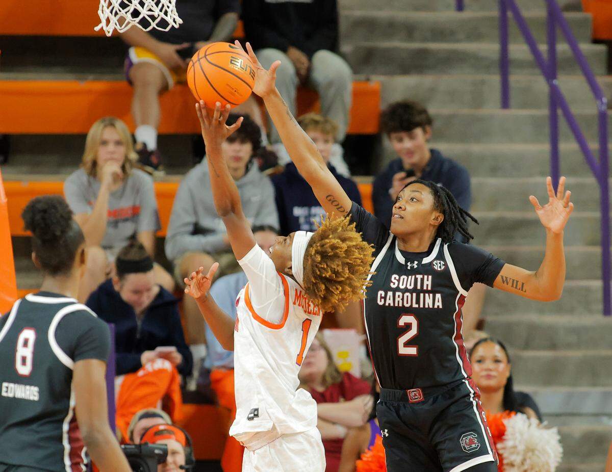 South Carolina forward Ashlyn Watkins (2) gets pressure on Clemson guard Loyal McQueen (1) during first-half action in Clemson, S.C. on Wednesday, Nov. 20, 2024.