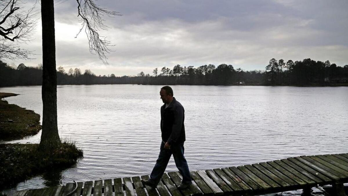 Simon Froese walks alongside Durham Pond on his family's property off Platt Springs Road, Monday, February 8, 2016. Froese still worries about the water quality of the pond 16 years after a chemical spill contaminated creeks and ponds in central Lexington County.