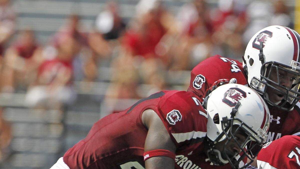 East Carolina Pirates wide receiver Jabril Solomon (83) is brought down by South Carolina cornerback Victor Hampton (27) and safety D.J. Swearinger (36) in the third quarter of the Gamecocks game against East Carolina at Williams-Brice Stadium.