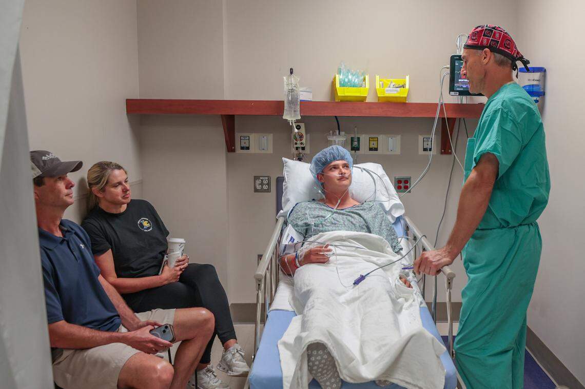 Dr. Christopher Mazoue speaks to Brandon Cromer and his parents, Brandon and Murray Cromer, before performing Tommy John surgery on Thursday, June 5, 2025, at Prisma Health Parkridge outpatient surgery.