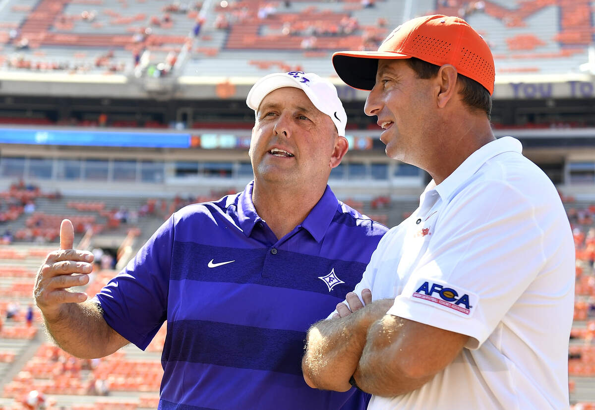 CLEMSON, SC - SEPTEMBER 01: Head coach Dabo Swinney of the Clemson Tigers and head coach Clay Hendrix of the Furman Paladins talk at midfield prior to the start of their football game at Clemson Memorial Stadium on September 1, 2018 in Clemson, South Carolina.