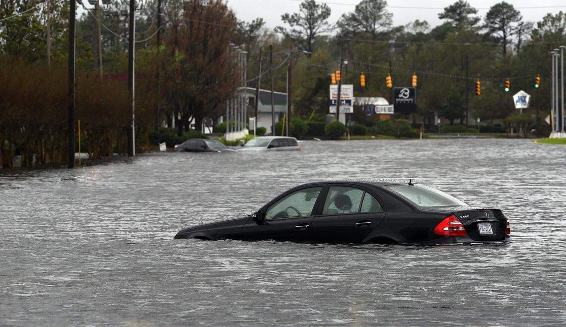 Abandoned cars sit in floodwaters near College Street Sunday, September 16, 2018 in Wilmington, N.C. during Hurricane Florence.