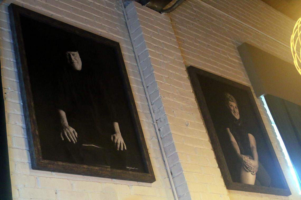 Portraits of Trustus Theatre founders Jim and Kay Thigpen look over the renovated bar at Trustus Theatre. Aug. 14, 2025