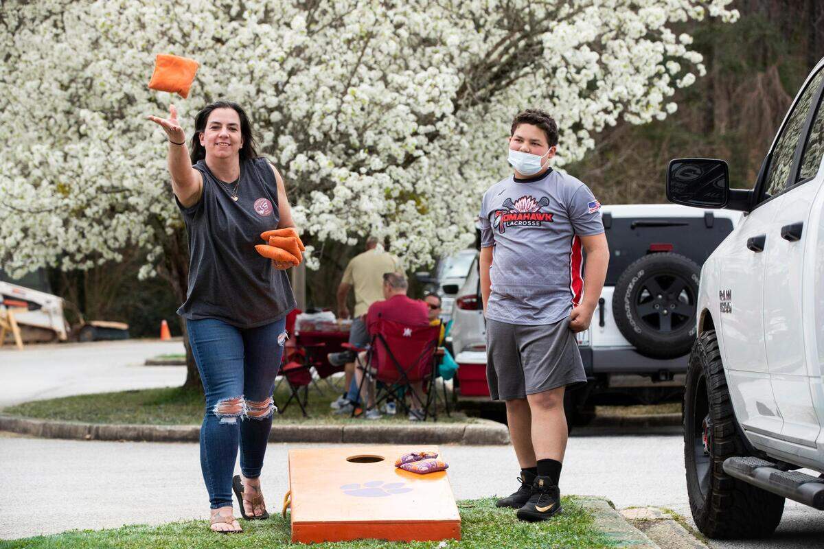 Christina Lackey and Tucker Houston play cornhole before Erskine College plays Shorter University at Greenwood High School on Saturday, March 13, 2021. Houston and his partner beat Lackey and her partner by 11 points.