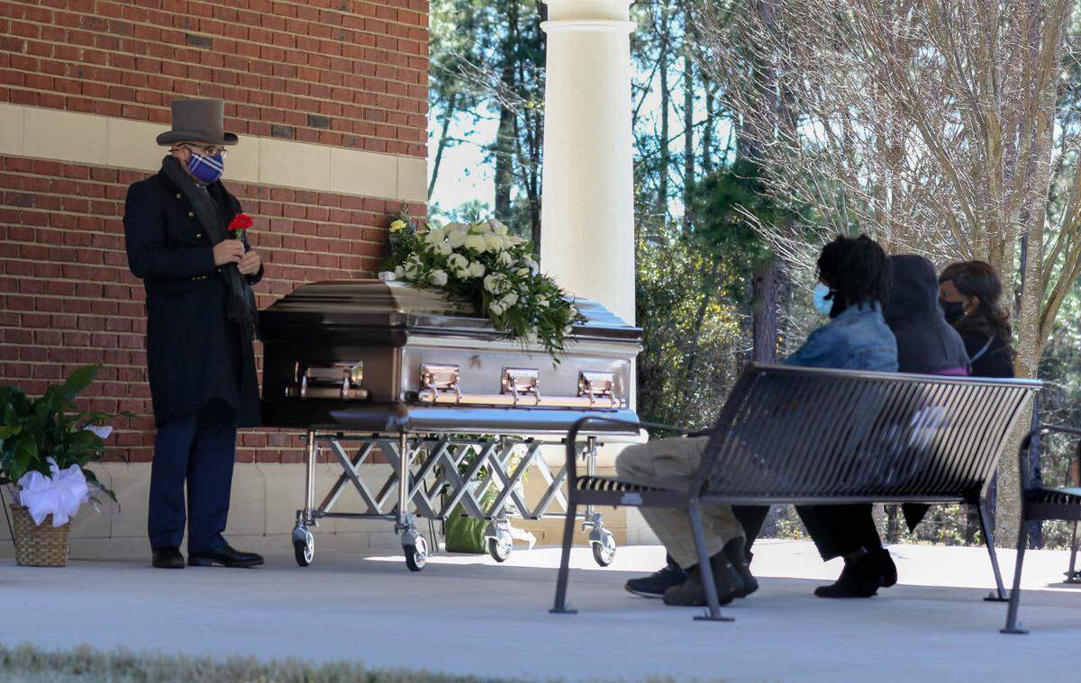 Chris Leevy Johnson officiates during the funeral for Jimmie Rice at the Fort Jackson National Cemetery. The graveside service. was only attended by close family members and was conducted with a simplified version of military honors.