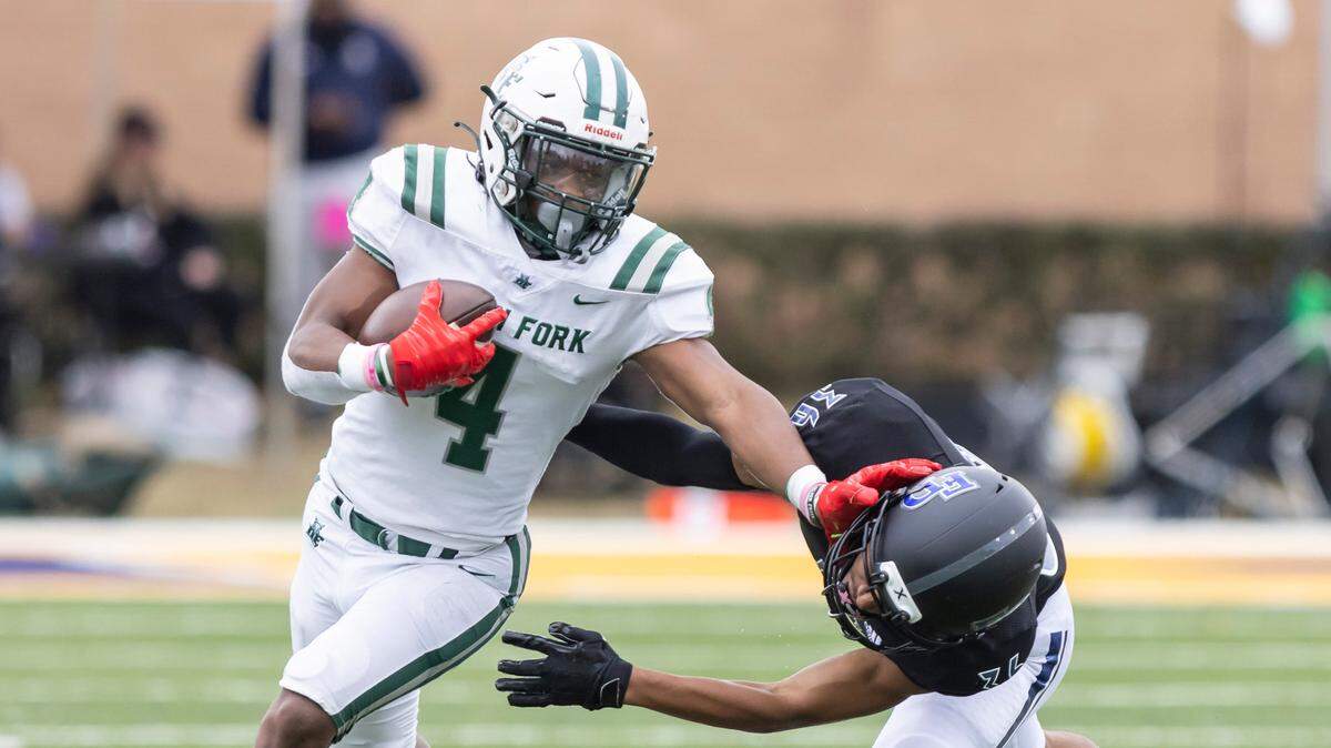 Jarvis Green (4) of Dutch Fork fends off the tackle of Jalen White (36) of Fort Dorchester during the SCHSL Class 5A Football State Championship at Charles W.Johnson Stadium in Columbia, SC on Saturday, Dec. 3, 2022.