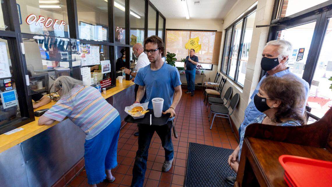 Mitchell Kolesar crosses a busy waiting area with his lunch at the What-a-Burger in West Columbia. The restaurant has been open on Meeting Street since 1953.