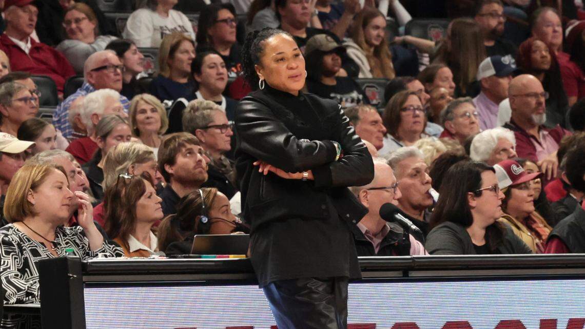 University of South Carolina Head Coach Dawn Staley leans against the scorers table during the second half of action against UConn in the Colonial Life Arena on Sunday, Feb. 16, 2025.