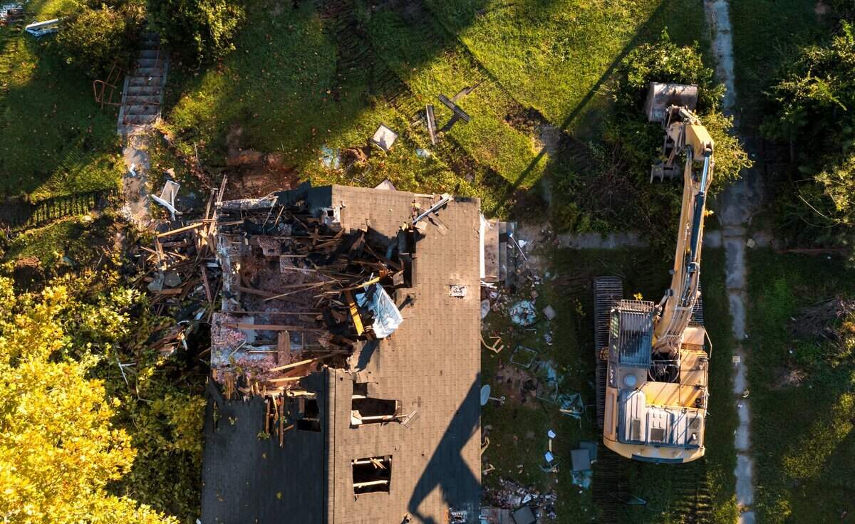 Crews demolish Allen Benedict Court Tuesday morning. The housing complex was built in 1940.