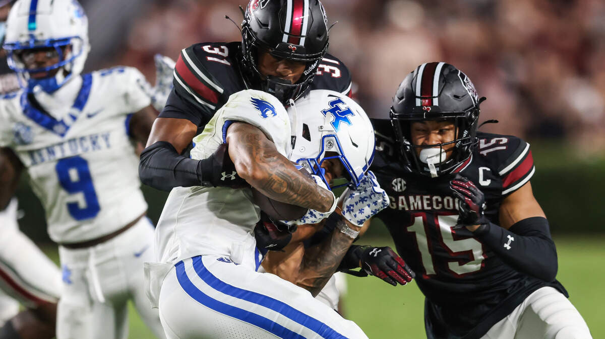 Kentucky running back Seth McGowan (3) is wrapped up by South Carolina defensive back Peyton Williams (31) and defensive back Brandon Cisse (15) during the Gamecocks’ game against Kentucky at Williams-Brice Stadium in Columbia on Saturday, September 27, 2025.