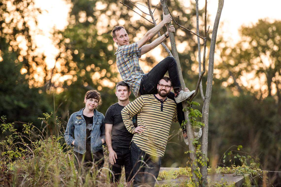 Aaron Graves, top, climbs a tree during a band photo shoot with wife Jessica Bornick, left, Pat Wall, and Chris Gardner, of Those Lavender Whales in Cayce, SC on Nov 6, 2017.