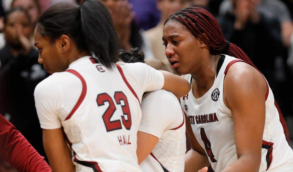 South Carolina Gamecocks guard Bree Hall (23) and forward Aliyah Boston (4) comfort a team member after losing to Iowa in the NCAA Tournament Final Four game at the American Airline Center on Friday, March 31, 2023.