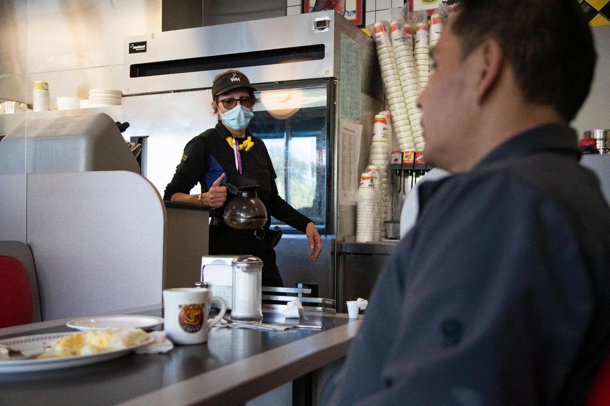 Myrtle Whitman pours a customer coffee at the Waffle House she manages on Wednesday, February 17, 2021. One of the things she likes about working at Waffle House is the welcoming atmosphere.