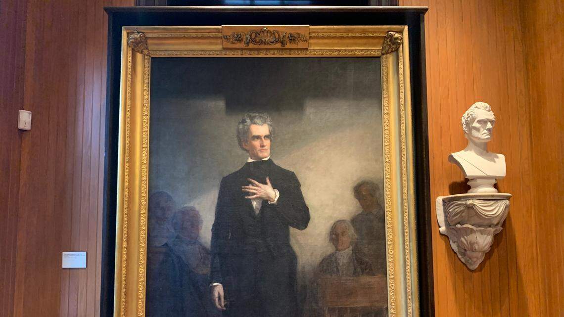 In a room connected to Charleston City Council chambers, a life-size portrait of John C. Calhoun, left, looks at a bust of his own likeness. The portrait, which was commissioned by the city in 1850, depicts Calhoun’s last Senate speech. What was painted, though, never happened.