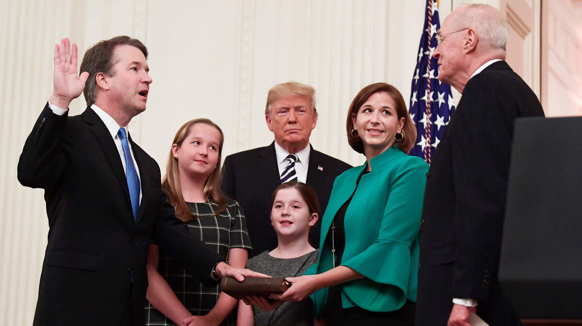 President Donald Trump, center, listens as retired Supreme Court Justice Anthony Kennedy, right, ceremonially swears-in Supreme Court Justice Brett Kavanaugh, left, in the East Room of the White House in Washington, Monday, Oct. 8, 2018. Kavanaugh’s wife Ashley watches, second from right with daughters Margaret, left, and Liza.