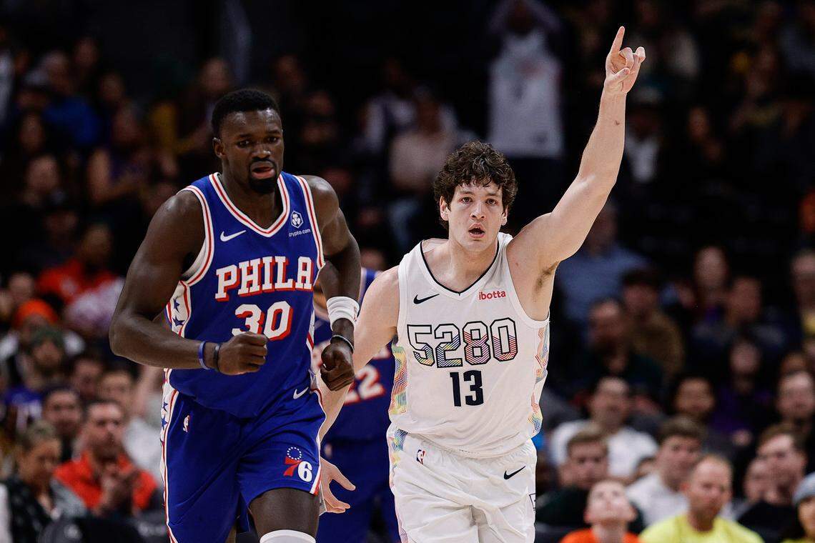Denver Nuggets center PJ Hall (13) gestures as he runs up court Jan. 21 next to Philadelphia 76ers center Adem Bona (30) in the fourth quarter at Ball Arena.