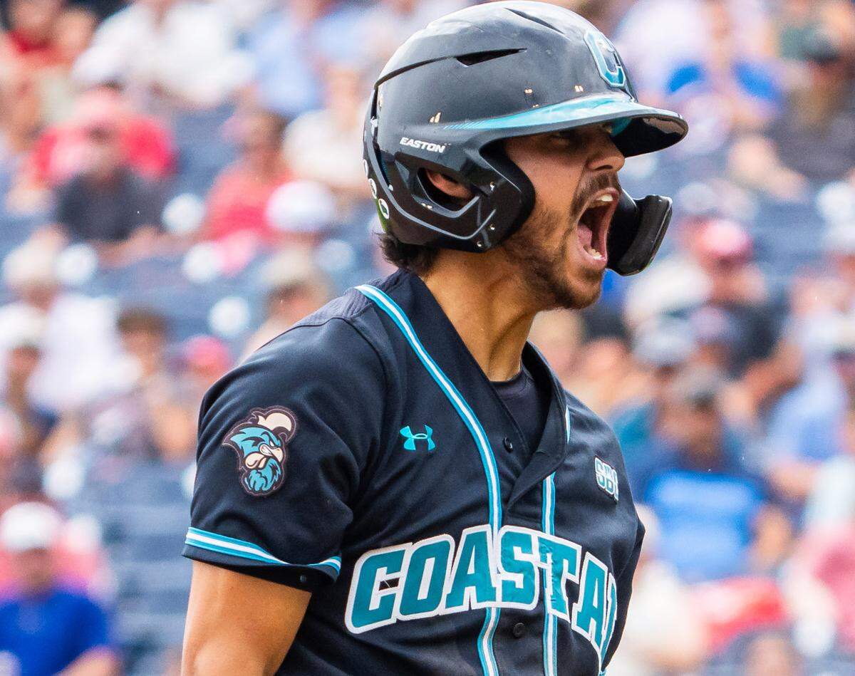 Coastal Carolina Chanticleers designated hitter Dean Mihos (8) celebrates after hitting a two RBI triple against the Louisville Cardinals during the fifth inning at Charles Schwab Field.