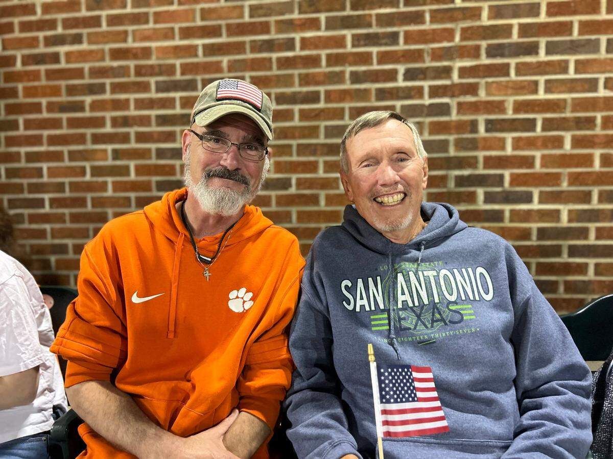 U.S. Army veteran Andy Norris (left) and U.S. Air Force veteran Dave Patterson (right) at an April 22 Clemson baseball game. Norris, 57, and Patterson, 74, were among the dozens of current and former service members who were honored (and received mini American flags) during the Tigers’ mid-fourth inning veterans tribute.