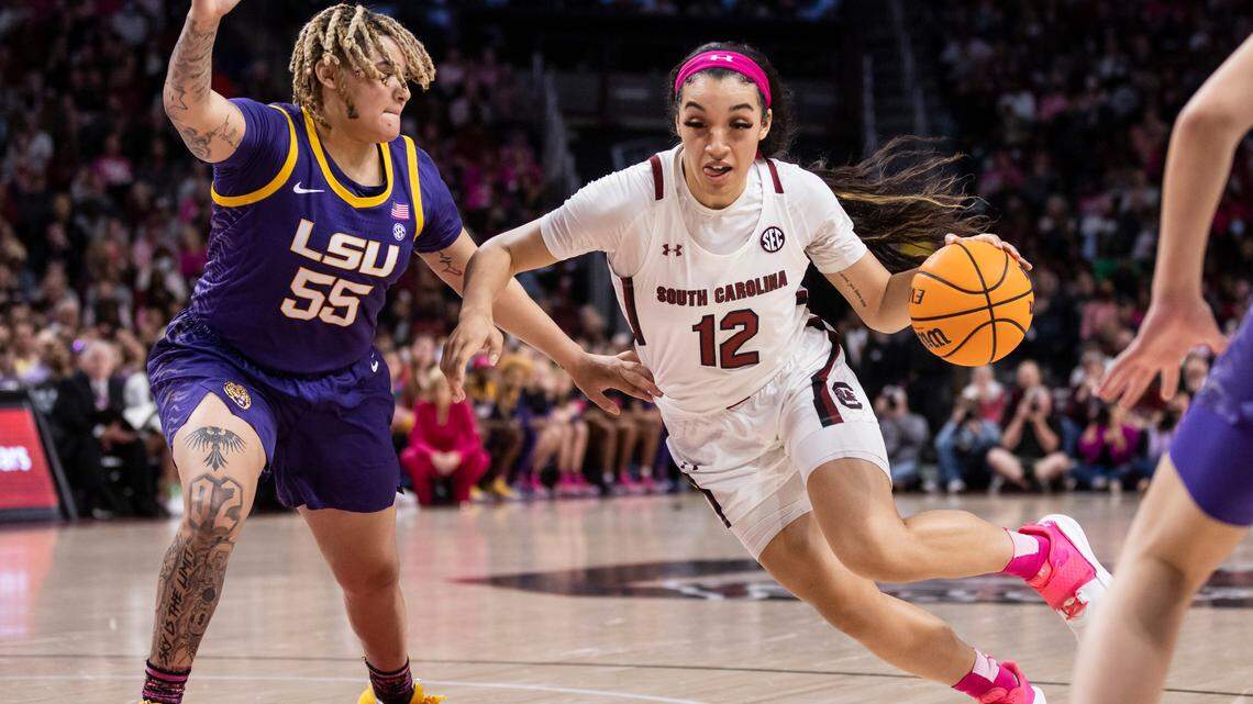 South Carolina Gamecocks guard Brea Beal (12) drives past LSU Tigers guard Kateri Poole (55) during South Carolina’s game against visiting LSU at Colonial Life Arena in Columbia on Sunday, February 12, 2023.