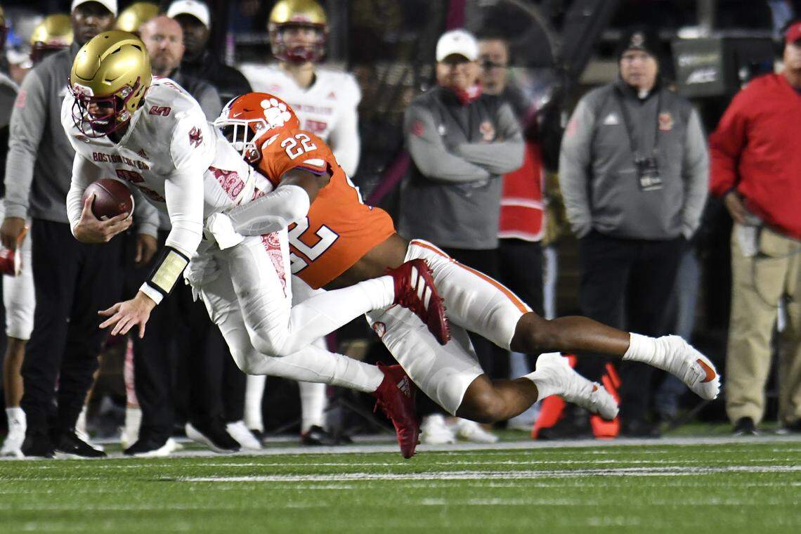 Clemson’s Trenton Simpson tackles Boston College quarterback Phil Jurkovec along the sideline during the first half of an NCAA college football game Saturday, Oct. 8, 2022, in Boston. (AP Photo/Mark Stockwell)