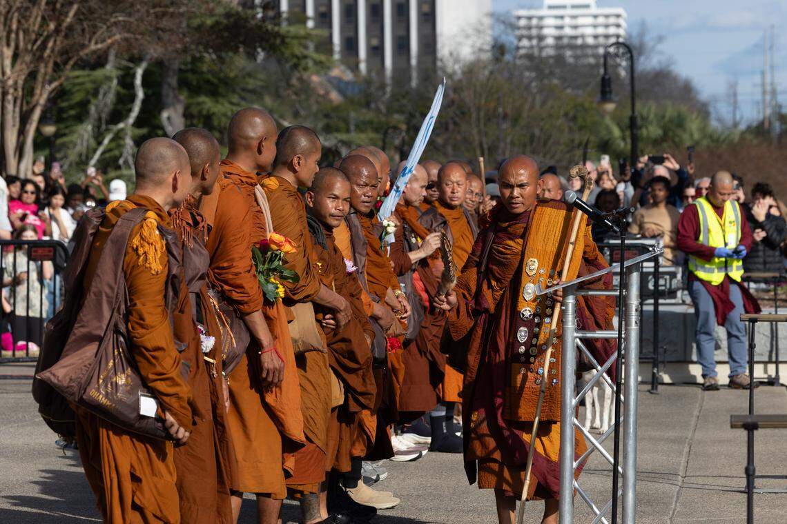 Buddhist monks stop to discuss methods for living a more peaceful life and pray for peace behind the South Carolina Statehouse in Columbia, South Carolina on Saturday, January 10, 2026. Thousands of people joined the walk to support the monk’s message of peace.