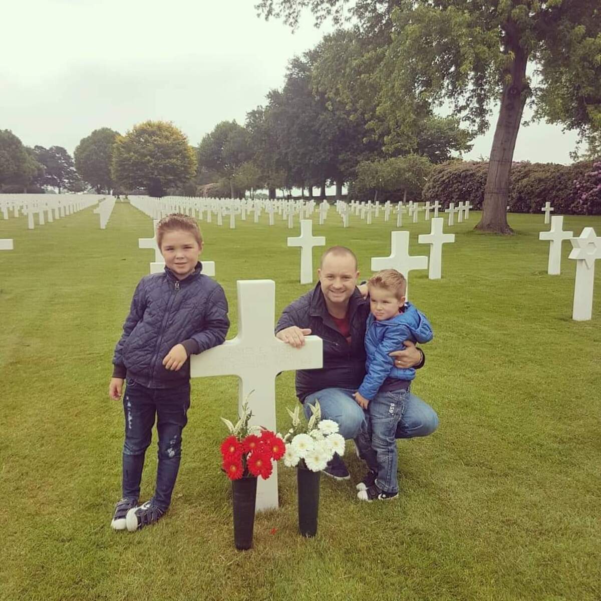 Stefan Warnier and his sons, Lenn and Wess, visit the grave of Pvt. First Class James E. Wise, of Dillon County, S.C., on Sept. 21, 2020, at the Netherlands American Cemetery in Margraten.
