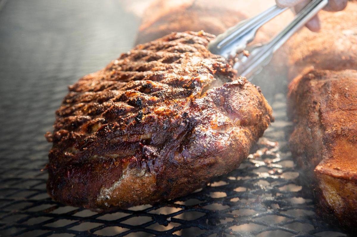 Chris Williams smokes brisket and pork at his restaurant, Roy’s Grille, located at a gas station in Lexington, South Carolina on Friday, January 7, 2022.