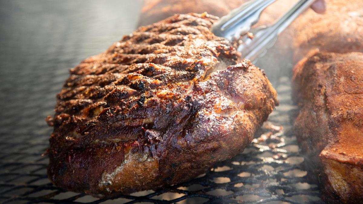 Chris Williams smokes brisket and pork at his restaurant, Roy’s Grille, located at a gas station in Lexington, South Carolina on Friday, January 7, 2022.