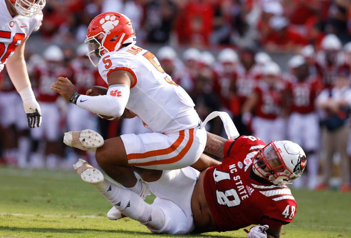 Clemson quarterback D.J. Uiagalelei (5) is sacked by N.C. State defensive tackle Cory Durden (48) during the first half of N.C. States game against Clemson at Carter-Finley Stadium in Raleigh, N.C., Saturday, Sept. 25, 2021.