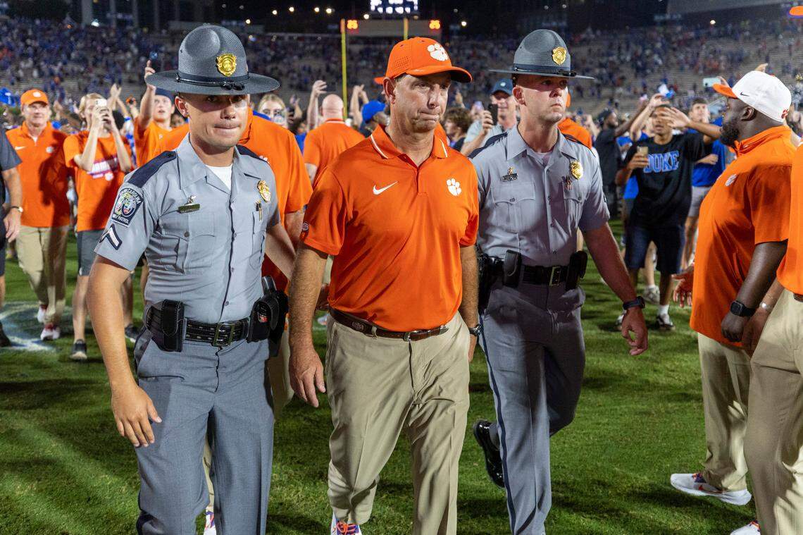 Clemson coach Dabo Swinney is escorted off the field as Duke fans celebrate their 28-7 victory over Clemson on Monday, September 4, 2023 at Wallace Wade Stadium Stadium in Durham, N.C.