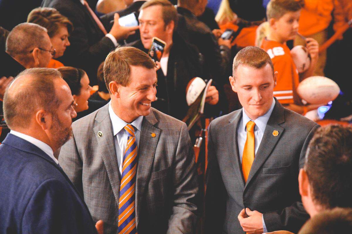 In his role as Clemson football director of communications, Ross Taylor (right) works closely with coach Dabo Swinney (left). Clemson football has won a Super 11 Award, presented by the Football Writers Association of America to programs that “exemplify excellent media relations,” each year of Taylor’s tenure.