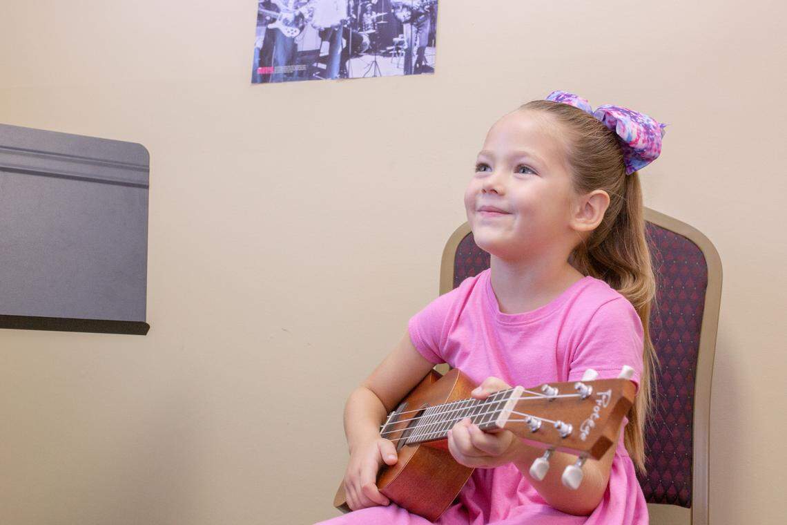 Rose Horton learns how to play the ukelele at the Columbia Arts Academy and uses the Musical Ladder System created by director, Marty Fort.
