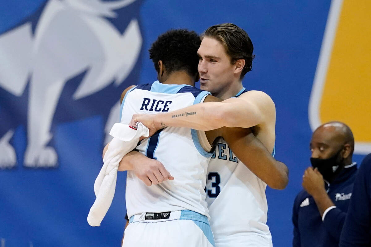 Citadel guard Kaiden Rice (11) hugs forward Hayden Brown (33) after their team defeated Western Carolina 100-86 in an NCAA first round men’s college basketball game for the Southern Conference tournament, Friday, March 5, 2021, in Asheville, N.C.