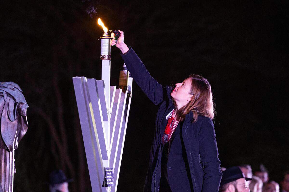 Ana Sazonov lights South Carolina’s menorah on the second night of Hanukkah at the South Carolina State House on Monday, December 19, 2022. Civis and religious leaders spoke about the importance of the holiday and fighting anti-semitism, before the traditional lighting of candles and latkes.