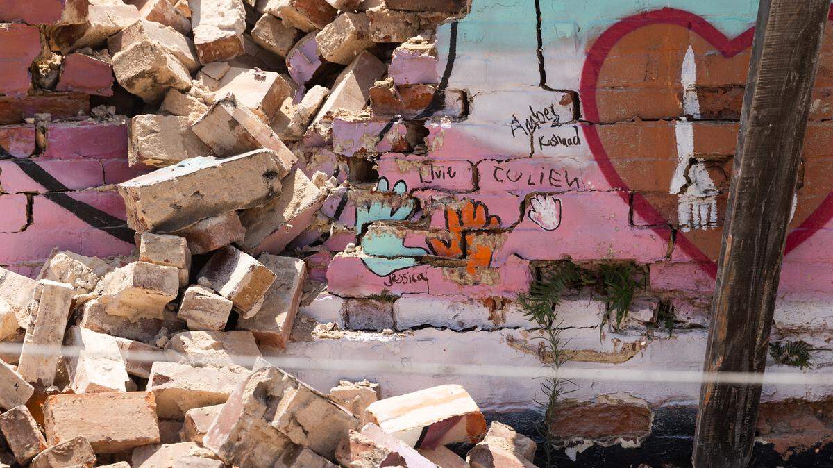 Jessica Bornick’s, widow to Aaron Graves, and their daughter’s handprints are still visible as the mural in honor of Aaron Graves is knocked down at the Hunter-Gartherer location on South Main Street in Columbia, South Carolina on Saturday, June 28, 2025. The building and mural were deconstructed after it was purchased by the USC Development Foundation.
