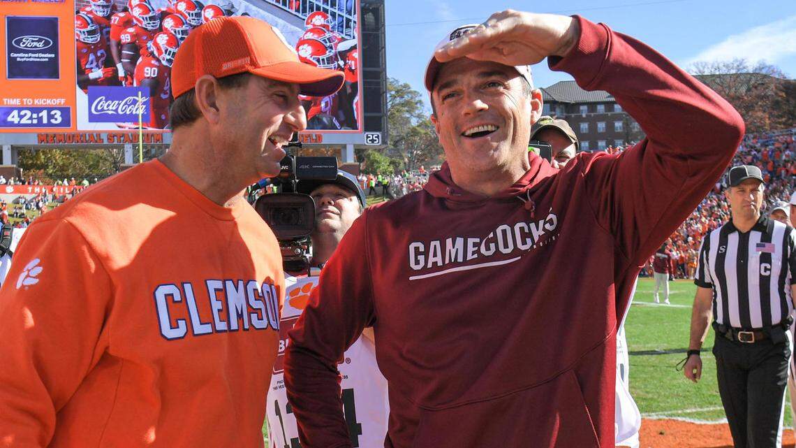 Nov 26, 2022; Clemson, SC, USA; Clemson head coach Dabo Swinney, left, and South Carolina head coach Shane Beamer talk before the game at Memorial Stadium in Clemson, S.C. Saturday, Nov. 26, 2022.
