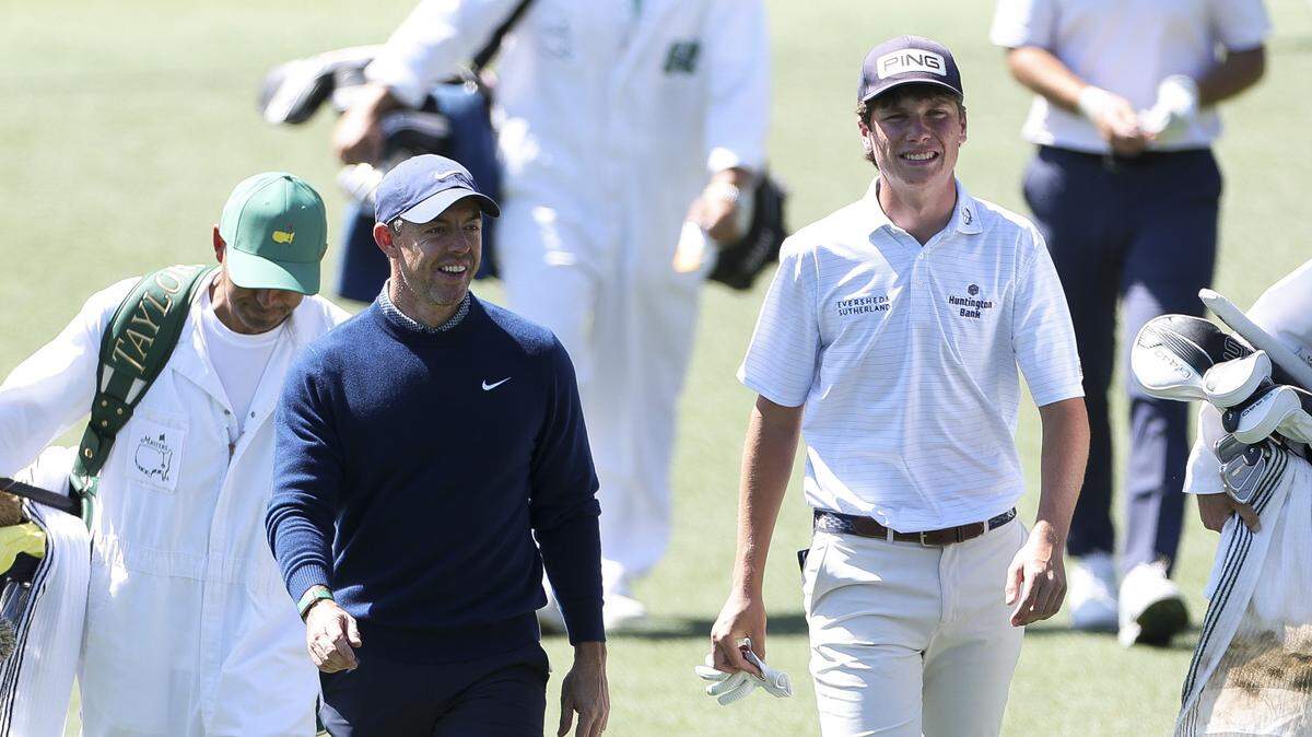 Rory McIlroy of Northern Ireland and amateur Mason Howell of the United States walk the 17th fairway Thursday during the first round of the 2026 Masters Tournament at Augusta National Golf Club .