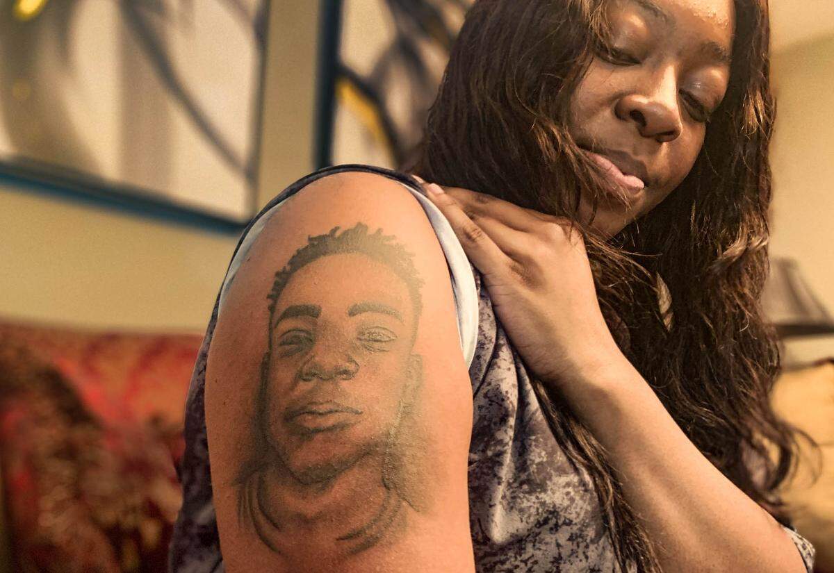 Aphrodesia ﻿McKelvey shows off a portrait of her son, Mikell McKelvey, that she got tattooed on her right arm. More than a year ago, she found Mikell, 15, dead in the parking lot of a West Ashley apartment complex after he had been shot and killed. His death remains unsolved.