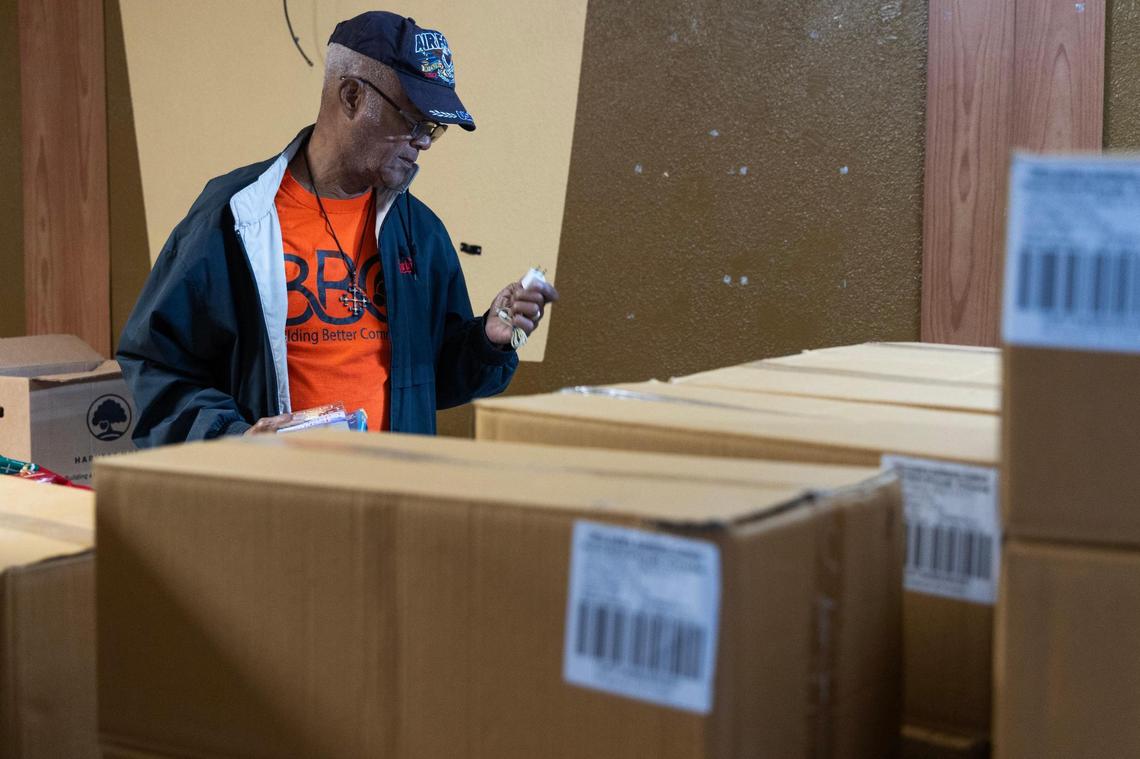 Volunteer Laurel Irving organizes resources at Building Better Community’s new resource center on Thursday, October 12, 2023.