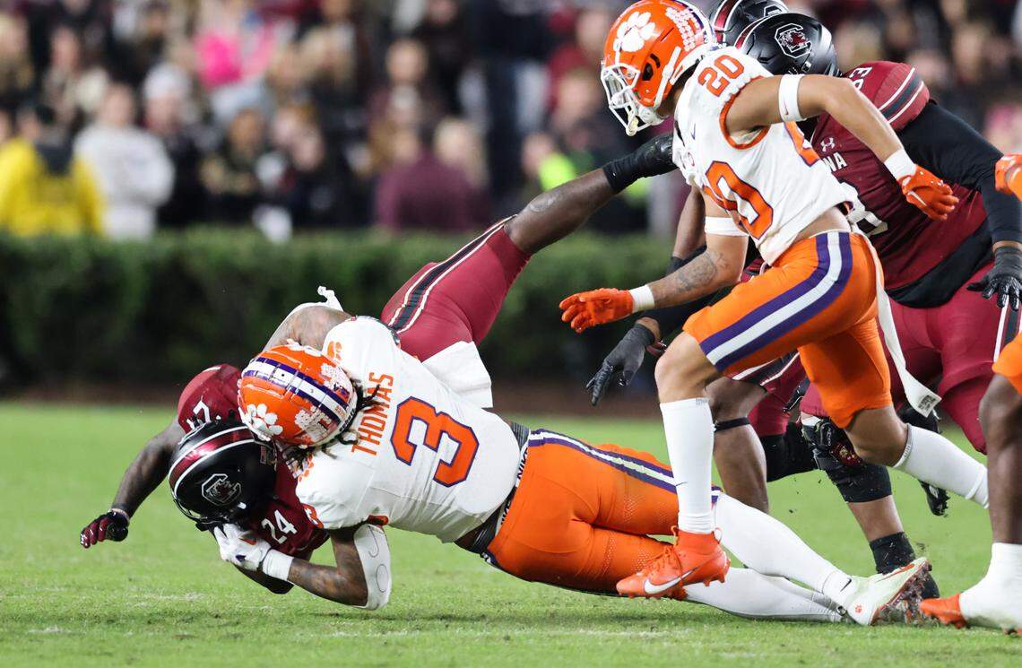 South Carolina running back Mario Anderson (24) gets thrown down by Clemson defensive end Xavier Thomas (3) during the first half of South Carolina’s game against Clemson at Williams-Brice Stadium in Columbia on Saturday, November 25, 2023.