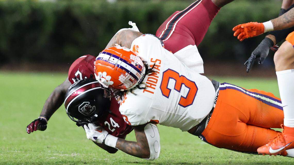 South Carolina running back Mario Anderson (24) gets thrown down by Clemson defensive end Xavier Thomas (3) during the first half of South Carolina’s game against Clemson at Williams-Brice Stadium in Columbia on Saturday, November 25, 2023.