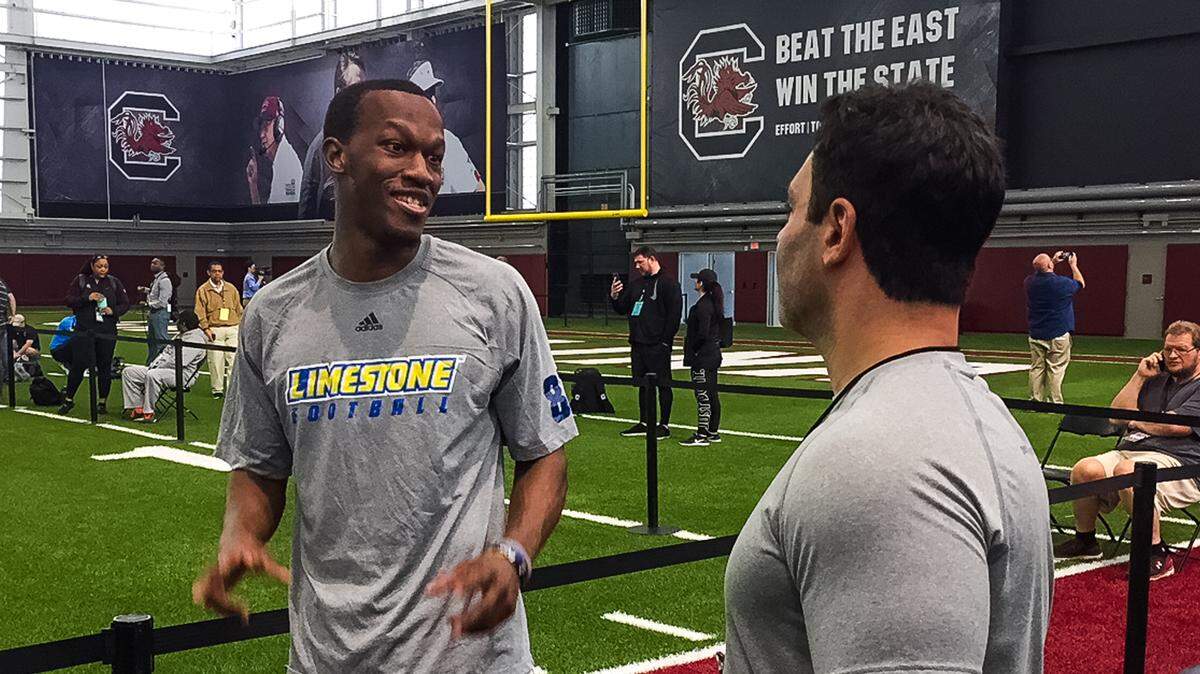 Columbia native Vyncint Smith, who played at Limestone, talks to his agent at South Carolina's Pro Day on Tuesday, March 20.