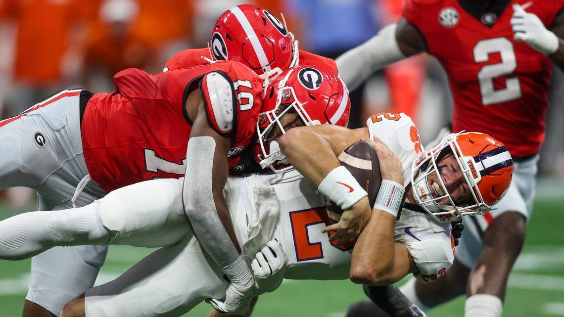 Clemson Tigers quarterback Cade Klubnik (2) is tackled by Georgia Bulldogs linebacker Damon Wilson II (10) in Saturday’s game at Mercedes-Benz Stadium.
