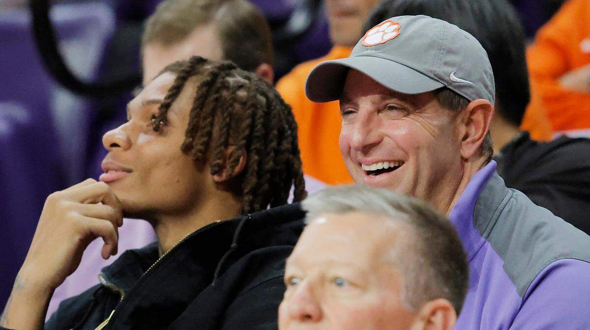 Clemson football coach Dabo Swinney and wide receiver Tristan Smith watch the South Carolina at Clemson men’s basketball game from the stands of Littlejohn Coliseum in Clemson, S.C. on Tuesday, Dec. 16, 2025.