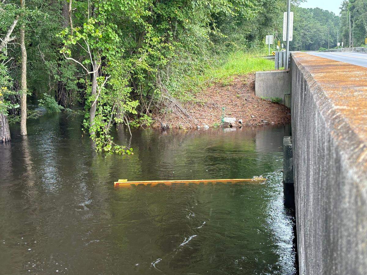 Tropical Storm Debby has left the Waccamaw River in between Longs and Conway flooded. A warning sign sits underwater while the river continues to rise.