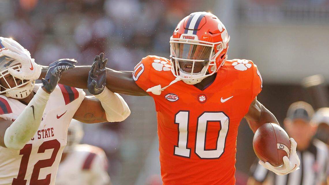 Clemson Tigers wide receiver Joseph Ngata (10) pushes South Carolina State Bulldogs defensive back Jaylen Evans (12) aside during second-quarter action in Clemson on Saturday.