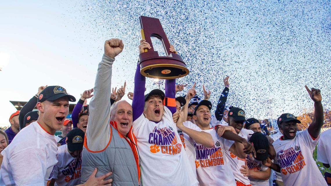 Clemson hoists the national championship trophy after defeating Washington in the NCAA college soccer tournament championship in Cary, N.C., Sunday, Dec. 12, 2021. (AP Photo/Ben McKeown)