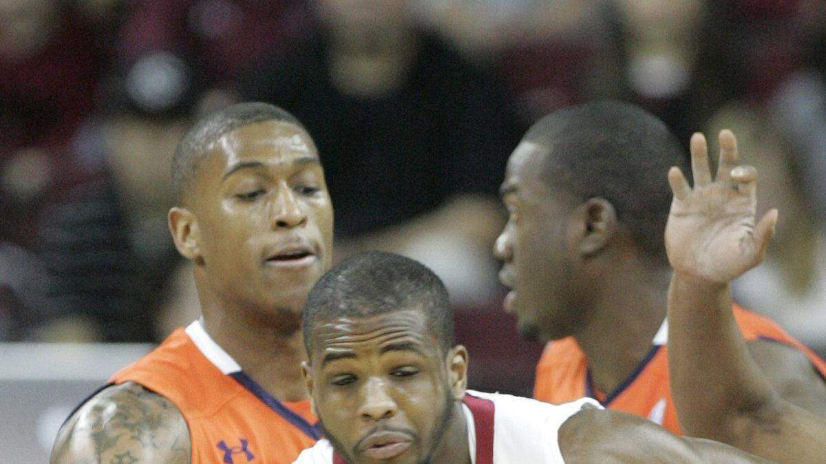 Sat,  Jan, 29, 2011-Columbia, South Carolina --South Carolina Gamecocks' Ramon Galloway fights to keep the ball from Auburn Tigers guard Earnest Ross (33) and Auburn Tigers guard Josh Wallace (11) during the first half of action Saturday against Auburn.