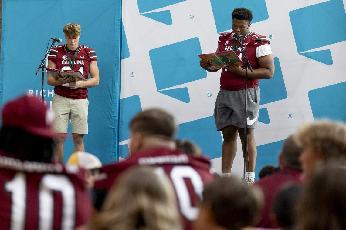 Masone Love (24) and Blake Franks (71) read a story at the annual Pigskin Poets event held Friday, July 12, 2024 at Drew Wellness Center in Columbia.
